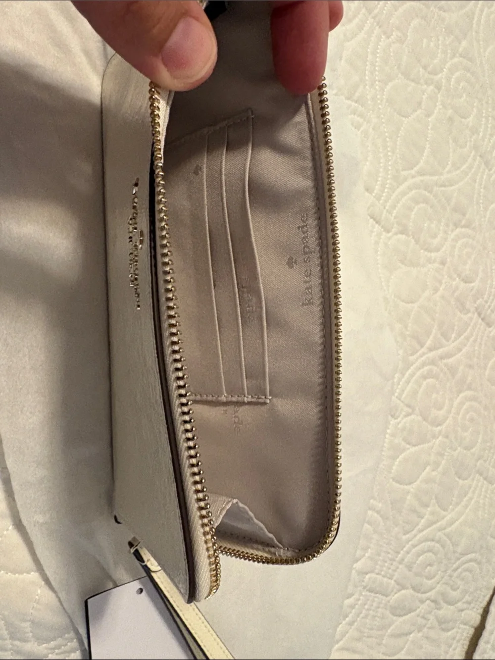 kate spade cream patent leather wristlet with gold logo